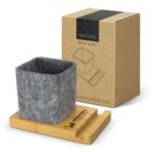 Gray felt caddy on a bamboo stand with packaging box labeled NATURA in the background.