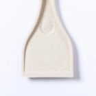 Beige plastic spatula with a flat, square-shaped head on a white background.