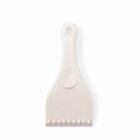 Beige plastic scraper with a hole in the handle and ridged edge, on a white background.