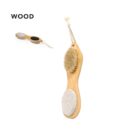 Wooden brush with bristles on one side and pumice stone on the other, hanging by a rope.