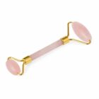 Pink jade facial roller with gold accents for skincare massage.