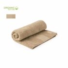 Rolled beige organic cotton towel with an Organic Cotton label in the corner.