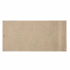 A plain beige rectangular bath towel laid flat on a white background.