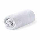A rolled-up light gray towel on a white background.