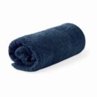 A rolled-up dark blue towel on a white background.
