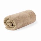 A rolled-up beige towel on a white background.