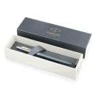 A black Parker pen in a gift box with a grey strap and gold logo on the lid.