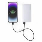 Smartphone connected to a power bank with a charging cable on a white background.