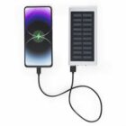 Smartphone connected to a solar power bank with a charging cable.