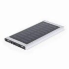 Slim rectangular solar power bank with multiple USB ports on a white background.