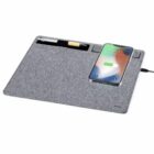 Gray desk pad with a pen holder and a smartphone charging wirelessly on the right side.
