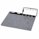 Gray desk mat with pen holders and a slot holding a smartphone displaying a calendar.