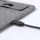A charging cable plugged into a grey fabric sleeve or pouch.
