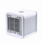 Small white portable air cooler with a front grille and a power button on top.