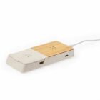 Rectangular dual wireless charger with wood and stone finish, plugged in with a white cable.