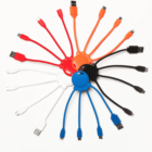 Colorful multi-USB cables arranged in a circular pattern on a white background.