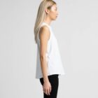 Woman in a sleeveless white top and black pants standing in profile against a plain background.