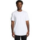 Man standing and wearing a plain white T-shirt and black pants against a white background.
