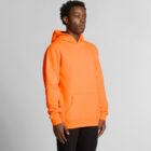 A person wearing a bright orange hooded sweatshirt and black pants stands against a plain background.
