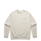 Beige long-sleeve crewneck sweatshirt with a small chest pocket, laid flat.