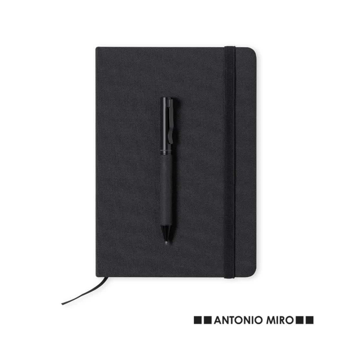 A black notebook with a pen placed on top and ANTONIO MIRO logo at the bottom right.