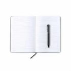 Open lined notebook with a black pen placed on its right page, viewed from above.