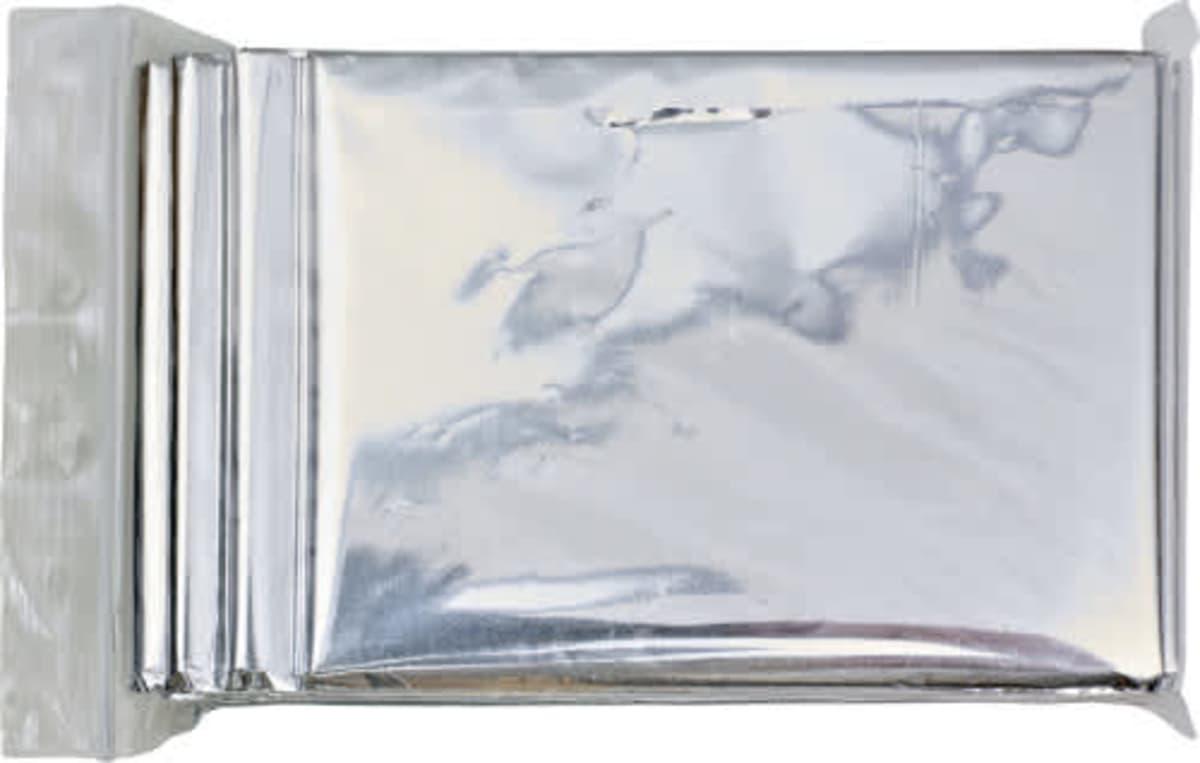 A silver, crinkled, rectangular foil wrapper, partially opened on one side, likely used for packaging a consumable item such as chocolate or snacks, set against a plain white background.