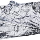 Crumpled silver foil sheets with a shiny, reflective surface. The texture is uneven, creating various highlights and shadows across the foil.