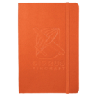Orange journal with a vertical elastic band on the right side. The cover features an embossed image of an airplane and the text CIRRUS AIRCRAFT below it.