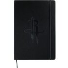 A black notebook with an embossed logo on the cover, featuring a stylized R with a circular, swooshing design around it. The notebook has a vertical elastic band for closure.
