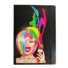 Notebook cover with an image of a woman with multicolored hair, vibrant paint splashes, and red lipstick. She holds a brush, and text reads ColourSplash High-Impact Branding.