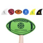 A hand holds a large, green, rugby ball-shaped fan with Green Garden printed on it. Above it, there are five smaller, surfboard fin-shaped fans in various colors, each with different logos or designs.