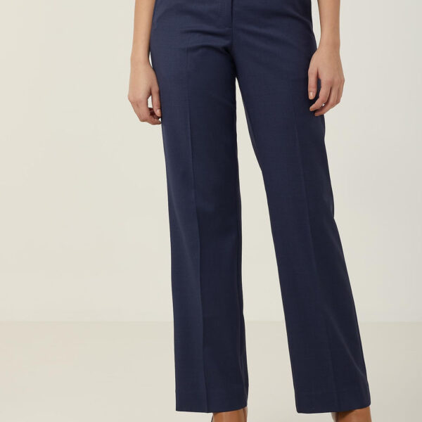 A person wearing high-waisted navy blue trousers and a red top. The pants have a tailored fit with flared legs. Brown heeled shoes complete the outfit. The background is plain light gray.