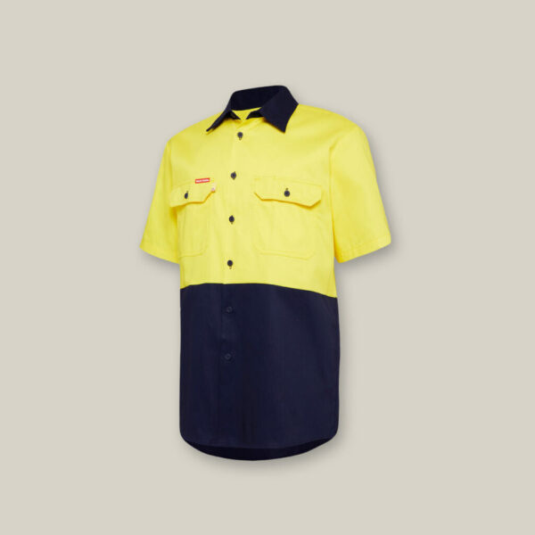 This short-sleeved shirt, with a yellow upper and dark blue lower half, includes two buttoned chest pockets and a front button closure. Ideal for outings with your Emz A5 Notebook, it stands out beautifully against a neutral background.