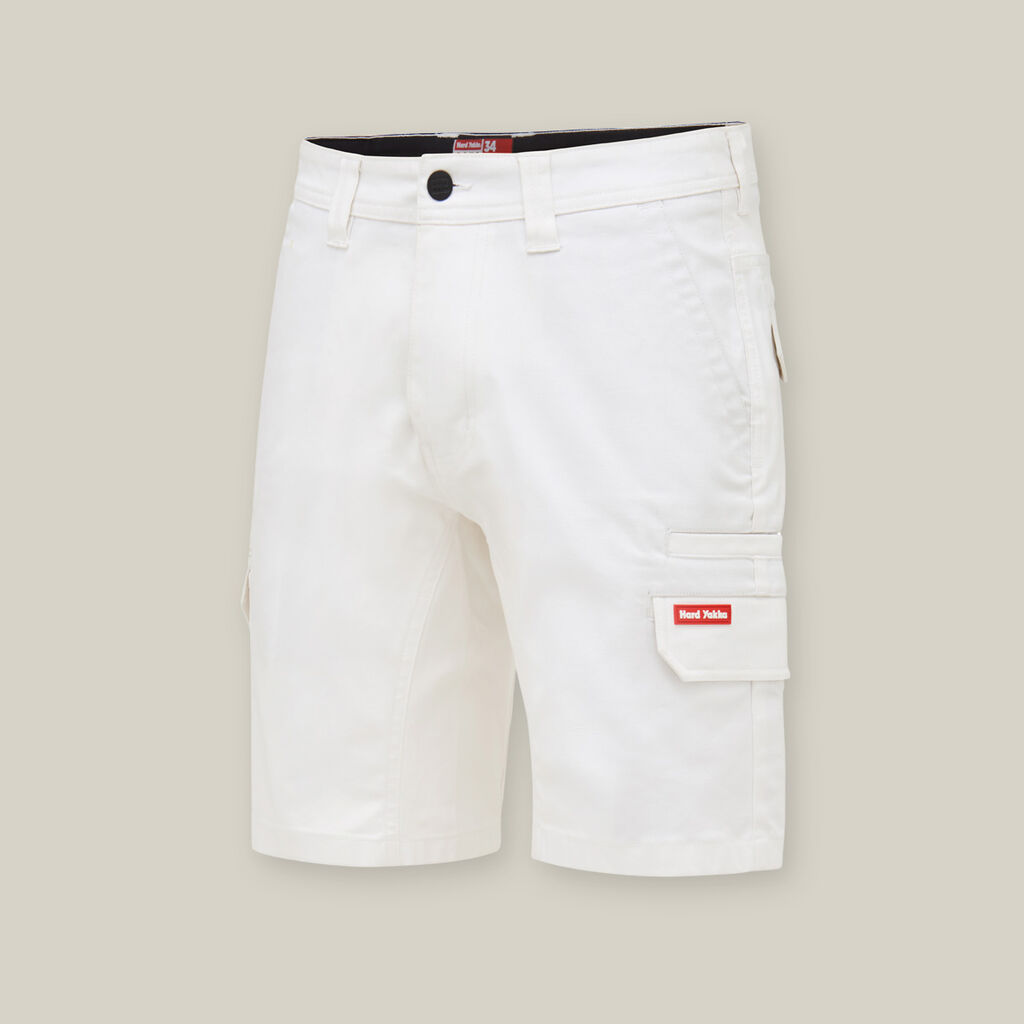 White cargo shorts on a light gray background, with multiple pockets ideal for essentials like the Emz A5 Notebook, featuring a small red and white label on one pocket.
