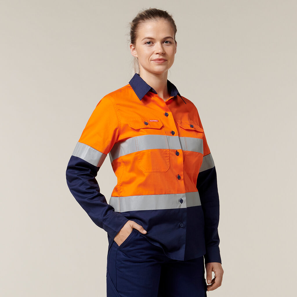 Woman wearing Explorer Shield hi-vis shirt with reflective stripes, smiling.