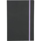 A closed, plain black notebook with a purple elastic band wrapped around it vertically. The notebook has no visible markings or designs.