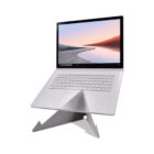 A silver laptop on a minimalist metal stand, screen showing a serene landscape.