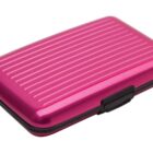 A closed metallic pink cardholder case with a ridged surface and black clasp.