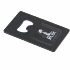 Black rectangular bottle opener with a Super Bowl XLIX logo in the bottom right corner.