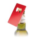 Red rectangular bottle opener on top of a beer bottle against a white background.