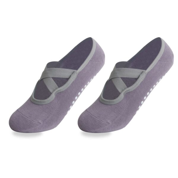 A pair of gray, ballet-style socks with crisscross straps and non-slip dots on the soles.