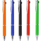 Five ballpoint pens in orange, blue, black, red, and green, standing upright in a row.