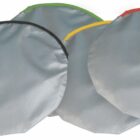 Four round silver pouches with colored edges: black, green, yellow, and red.