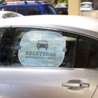 Car door with a sign reading SPINTERNS stuntmen and women and a car icon in a circle.