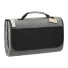 Gray and black folded picnic blanket with handle and label, displayed on a white background.