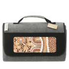 Gray and black picnic blanket with a handle and colorful dotted abstract pattern on the front.