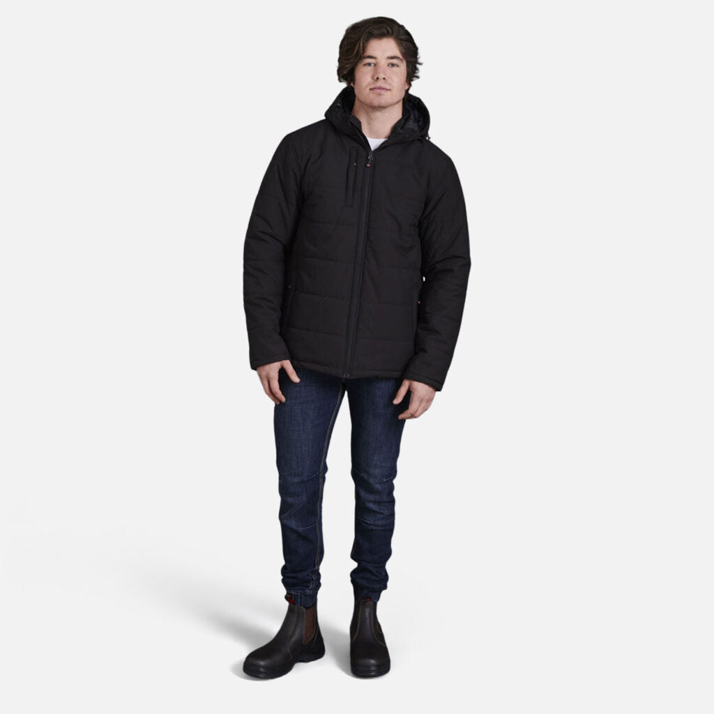 Man in black jacket and Explorer Shield boots stands against a white background.