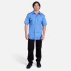 Man wearing the Explorer Shield blue short-sleeve shirt and black pants on a white background.