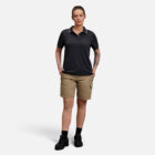 Person wearing Explorer Shield polo, khaki shorts, and black shoes with emblem.